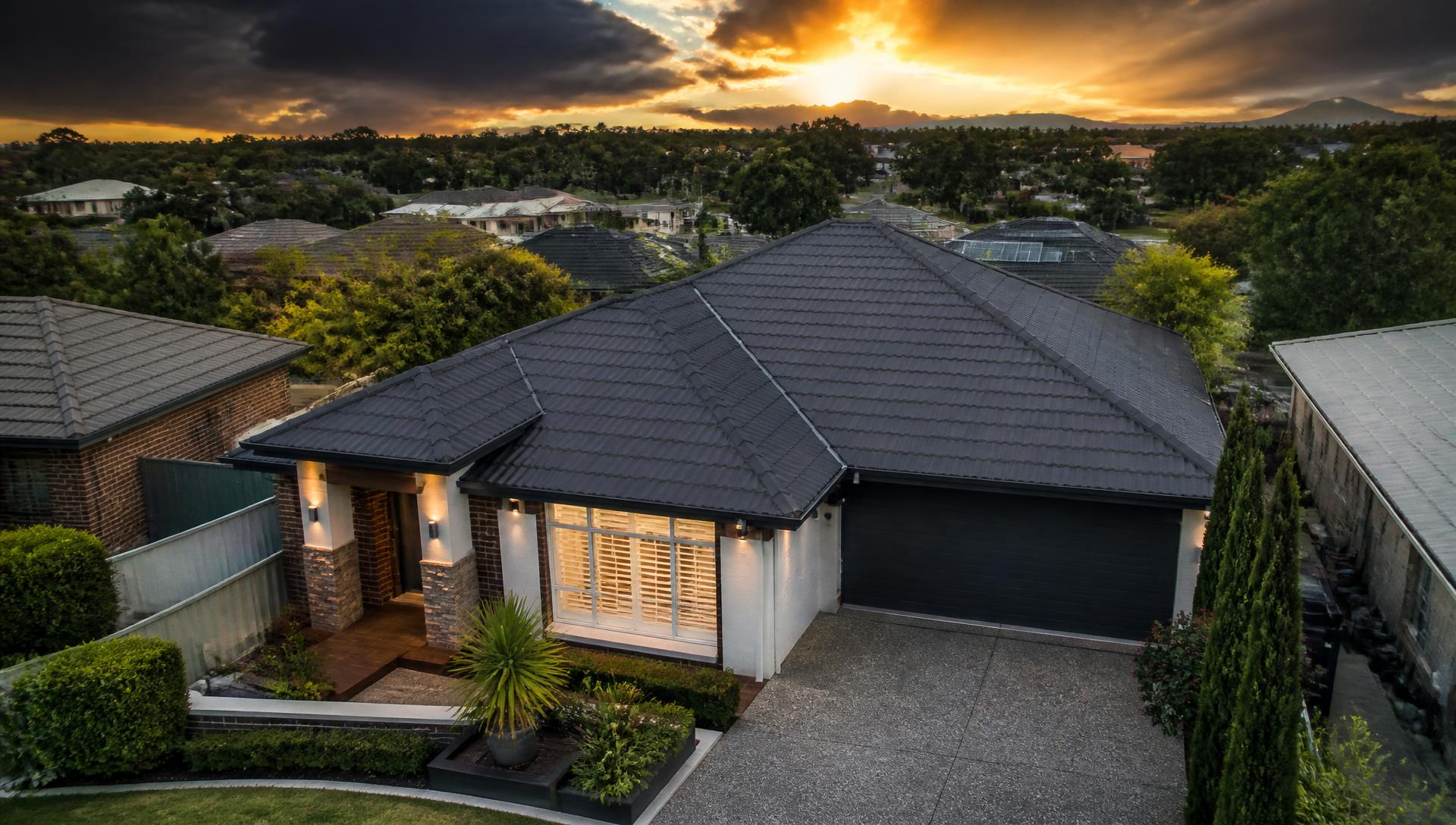 Australian home with freshly restored dark roof at sunset